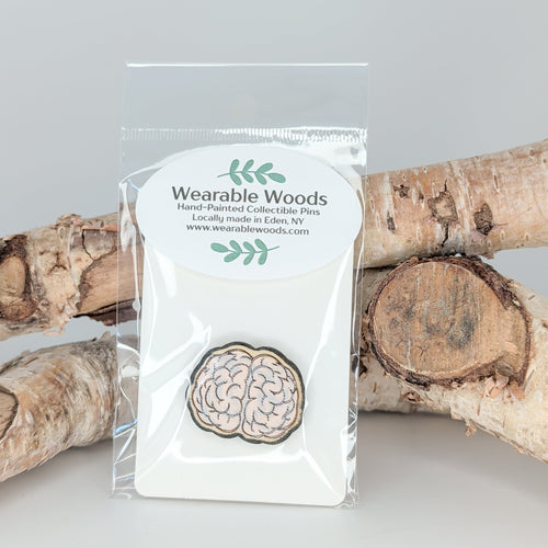 Wearable Woods product in packaging with wooden logs in the background